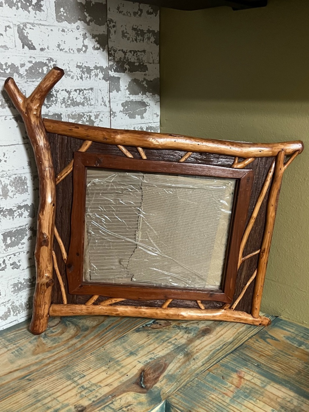 Custom handmade rustic wood picture frame featuring an organic, Adirondack-style